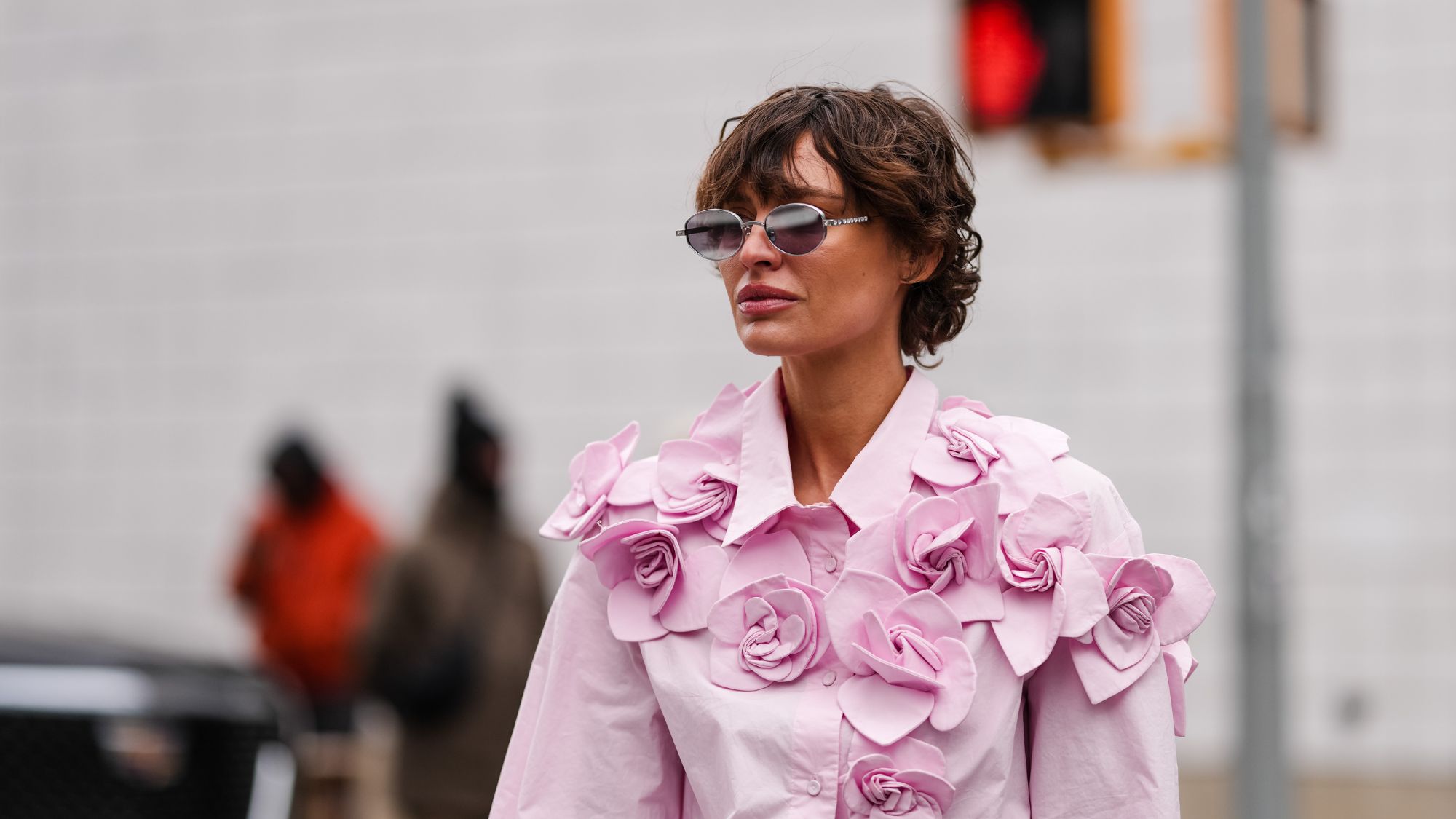 a woman wearing a floral shirt