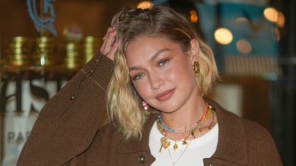 Gigi Hadid wearing soft contrasting makeup with rosy blush and necklaces