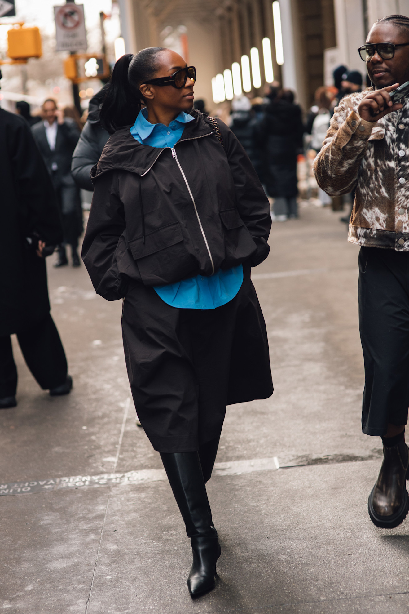 A woman wears oversize sunglasses during fashion week