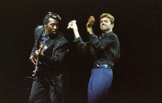 LONDON, UNITED KINGDOM - JUNE 15: Bass player Deon Estus and George Michael perform on stage on the 'Faith' tour, at Earls Court Arena on June 15th, 1988 in London, England. (Photo by