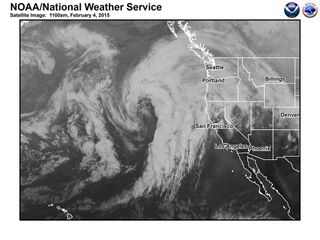 A satellite image showing water vapor streaming across the Pacific Ocean in a narrow band, typical of an atmospheric river.