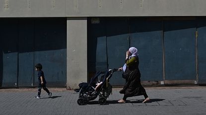 A Muslim woman walks down a street in London