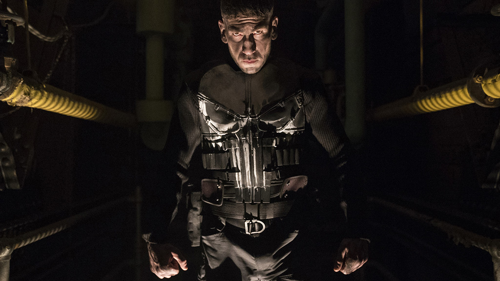 Jon Bernthal's Punisher emerges from the shadows with the comic book character's iconic costume, complete with spray painted skull on the front