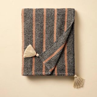 A gray and orange striped blanket