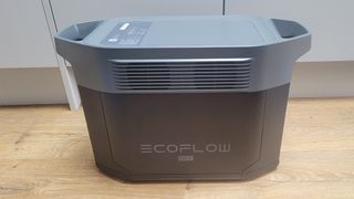 EcoFlow DELTA 2 Max power station on a wooden floor in front of gray cabinets