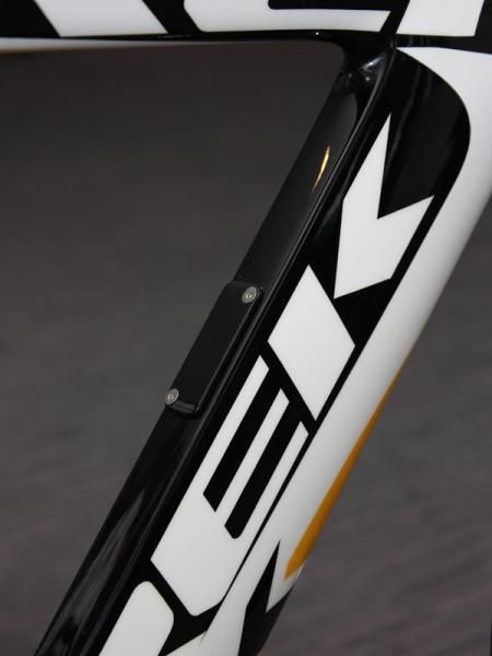 The small access port on the back of the down tube presumably facilitates installation of the internally routed cables.