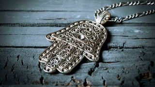 A khamsa, or hamsa, amulet with five fingers, whcih inspired the Enigma's unusual size and shape.
