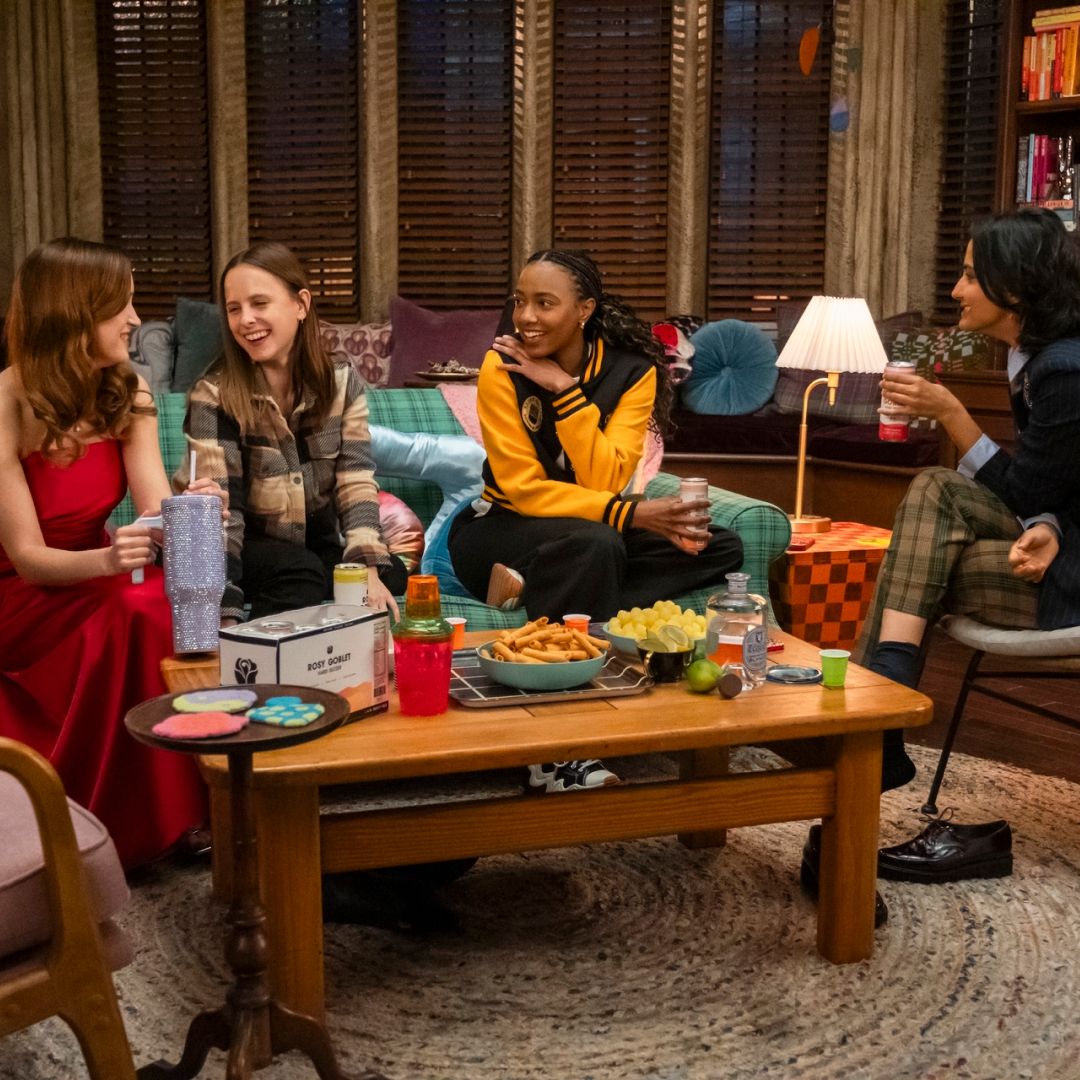 Four college students (Gracie Lawerence, Pauline Chalamet, Alyah Chanelle Scott, Amrit Kaur) hold drinks while sitting around a coffee table in a dorm room, in &#039;The Sex Lives of College Girls.&#039;