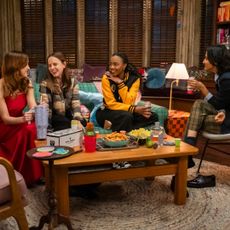 Four college students (Gracie Lawerence, Pauline Chalamet, Alyah Chanelle Scott, Amrit Kaur) hold drinks while sitting around a coffee table in a dorm room, in 'The Sex Lives of College Girls.'