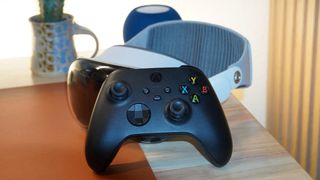 An Xbox controller leaning on Vision Pro.