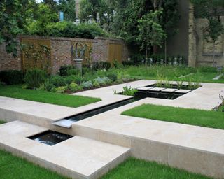 walled garden design with a semi formal pond surrounded by paving