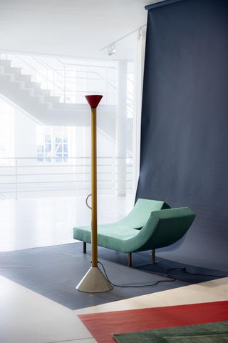 Lamp by Ettore Sottsass and minimalist sofa design in teal