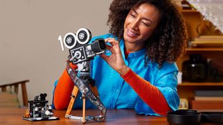 Girl building Lego 43230 Disney Tribute Camera set