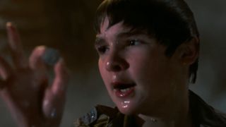 Mouth holding a coin in The Goonies