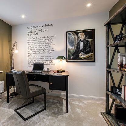 home office with white wall painting frame work desk grey desk