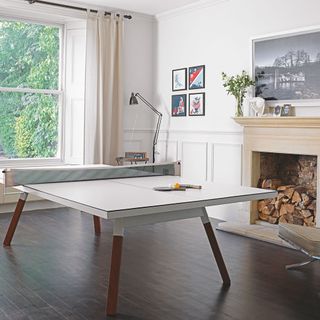 games room with ping pong table and white wall