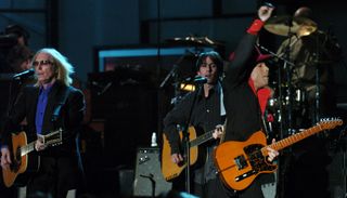 (From left) Tom Petty, Dhani Harrison, and Prince perform onstage