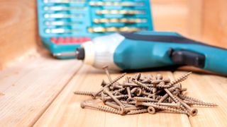 screws with square flat heads in front of defocused impact driver and drill bit kit. 