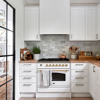 A white kitchen with marbles splashback
