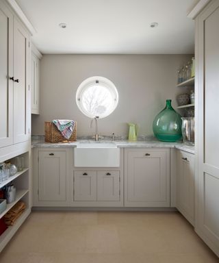 utility room with neutral cabinets