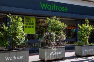 Exterior of Waitrose store in London, with planters outside