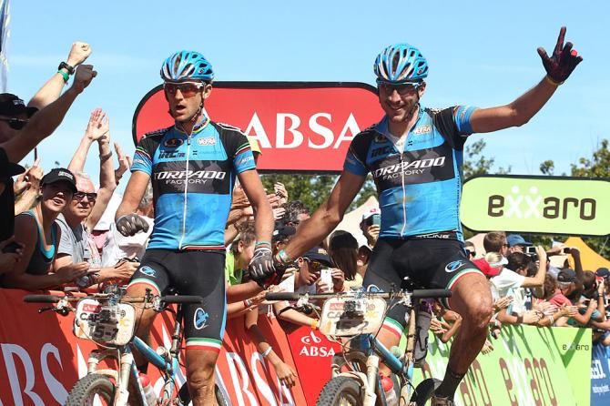 Roel Paulissen and Riccardo Chiarini of Torpado Factory celebrate as they cross the line to win the 5th stage