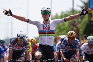 UAE Team Emirates XRG's Slovenian rider Tadej PogaÄar (C) celebrates as he crosses the finish line to win the 1st stage of the 77th edition of the Criterium du Dauphine cycling race, 195,8 km between Domérat and Montlucon, on June 8, 2025. (Photo by Anne-Christine POUJOULAT / AFP)