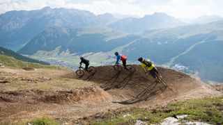 Mountain bike riders on a flow trail in the Italian Alps
