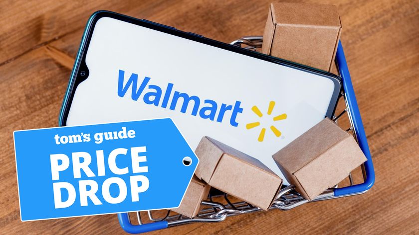 Smartphone displaying Walmart logo shown on mini shopping cart