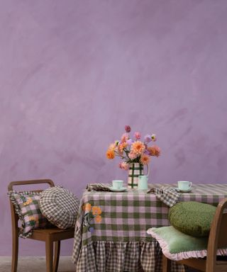 Table skirt in a purple painted room