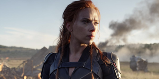 Natasha Romanoff stands in front of smoking debris in 'Black Widow'