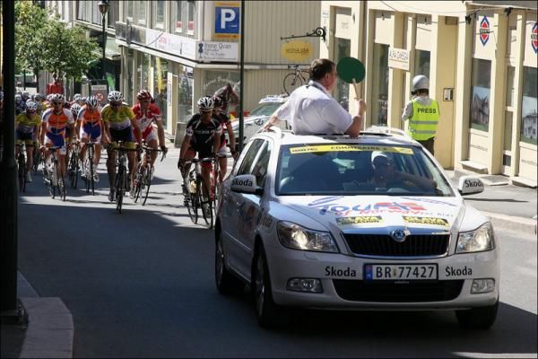 The race chief lets riders know when the neutral zone finishes.