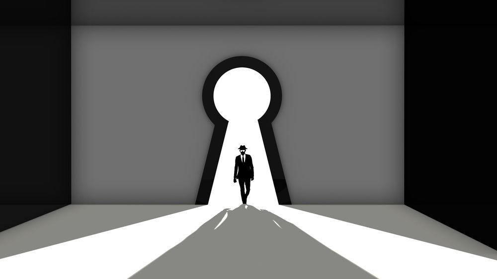 A man walking through a keyhole