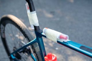 Colnago gravel frame with sealant strapped to the seat tube.