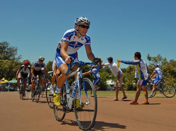 A rider in the elite men's field rides through the feed zone.