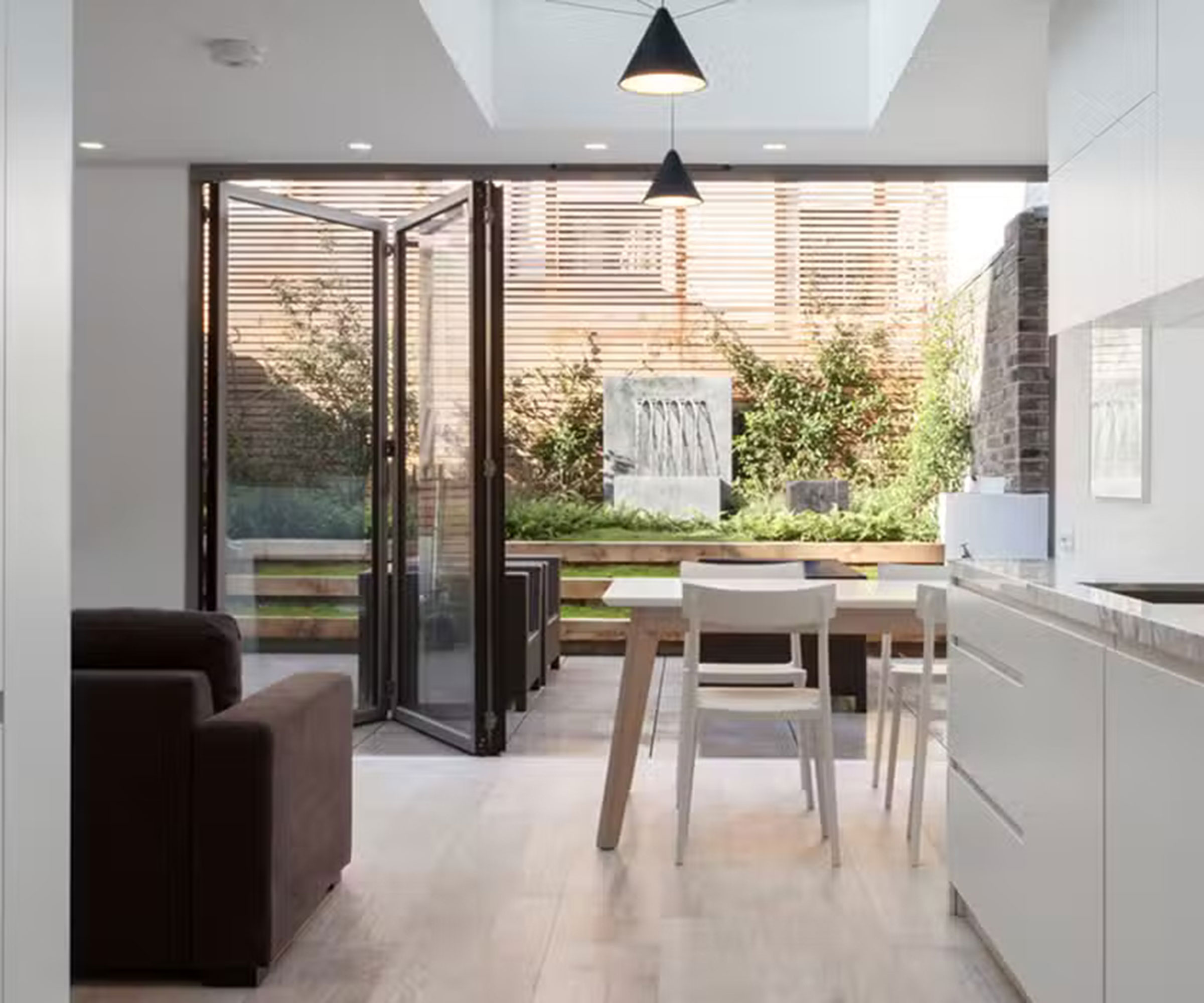 kitchen extension with bifold doors leading out to a small rear garden and patio