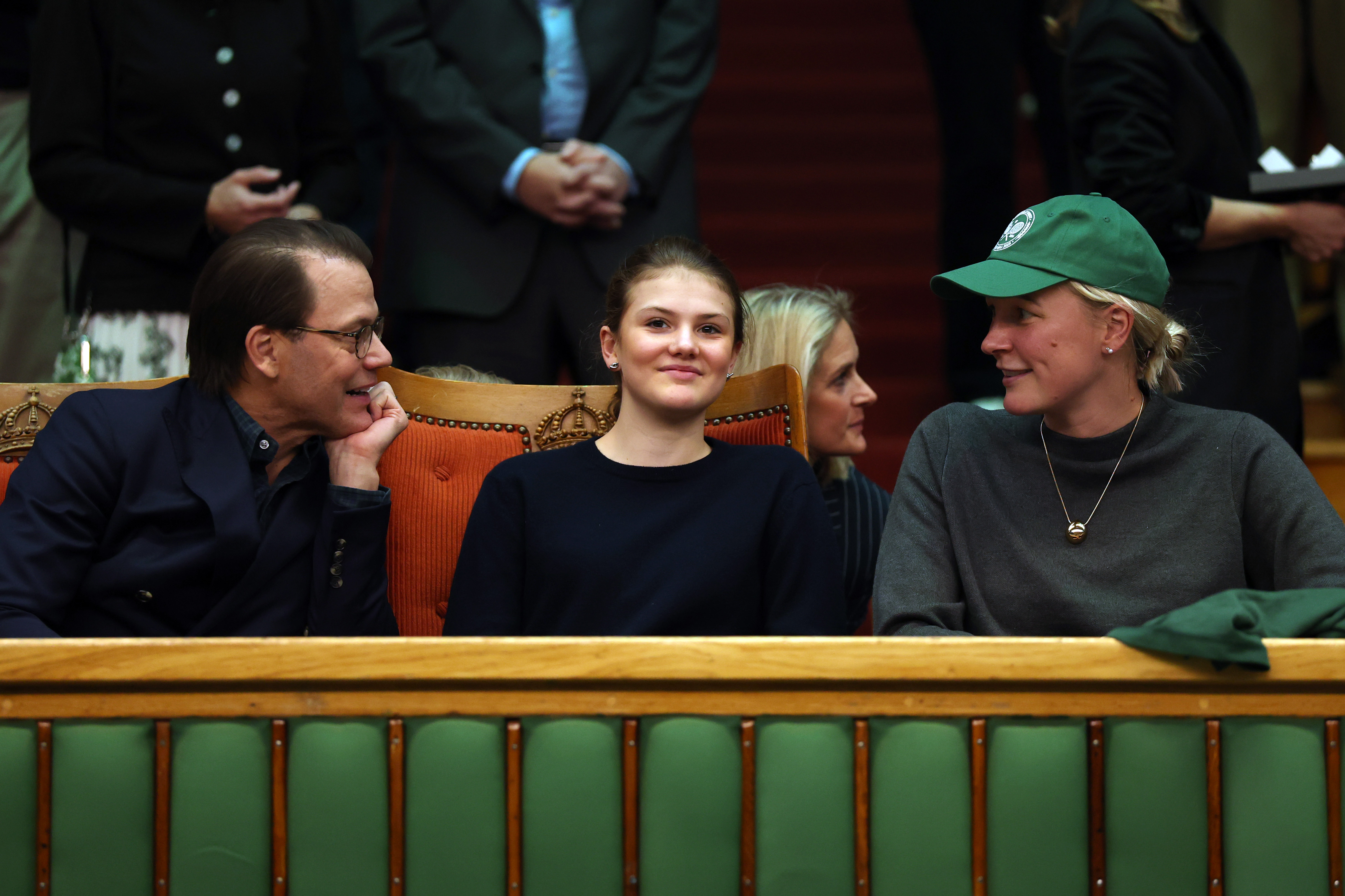 Prince Daniel turning to talk to swimmer Sarah Sarah Sj&amp;ouml;str&amp;ouml;m while watching a tennis match with Princess Estelle