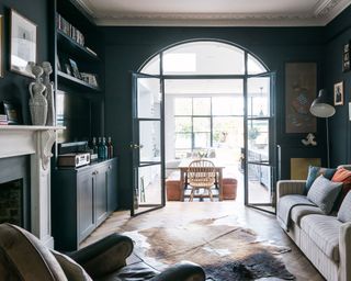 Open-plan living room with grey walls and glass door