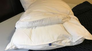 A Casper Down Pillow opened up to show its adjustable fill