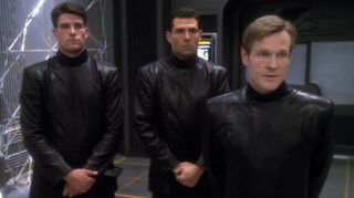 a screenshot from Star Trek Deep Space Nine showing three characters uniformed in all black