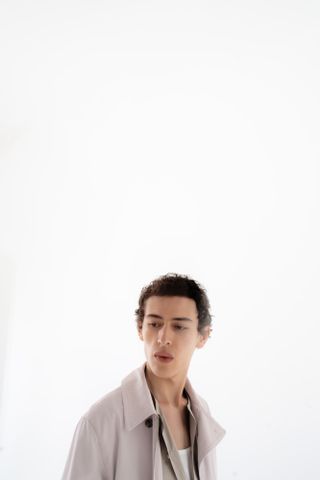 Boy on white background wearing outfit by Hermès