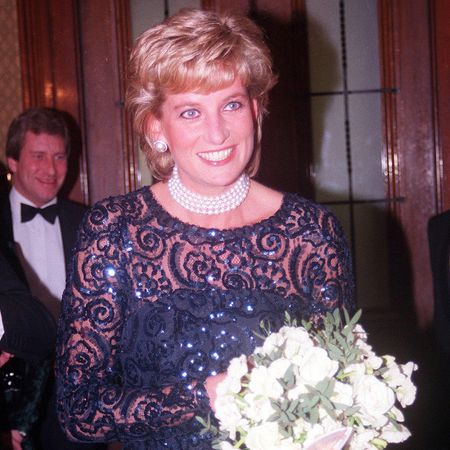 England's Princess Diana in short black lacey dress  pearl choker w. bouquet arriving at a charity event at the Royal Albert Hall. (Photo by Ken Goff/Getty Images)