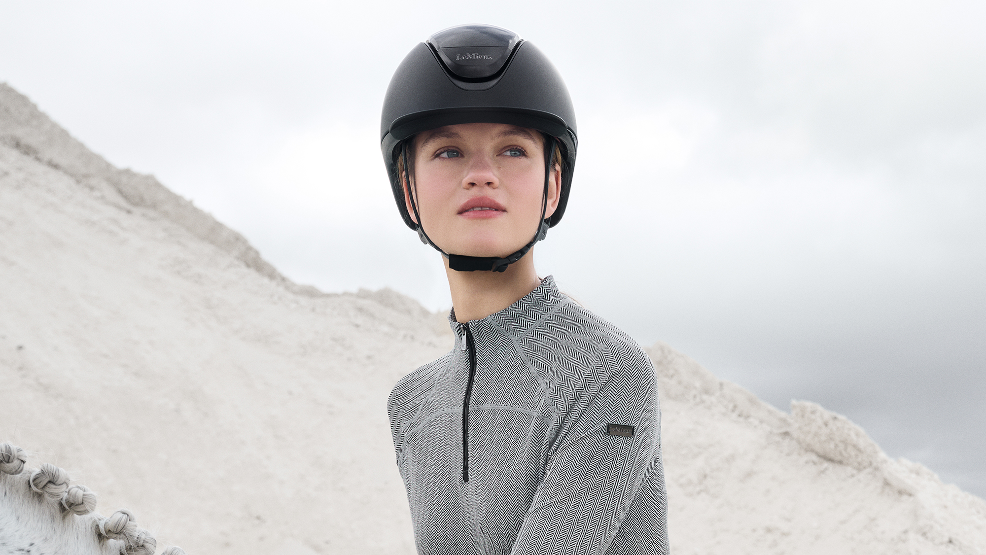 Lady riding wearing a LeMieux Verv riding helmet