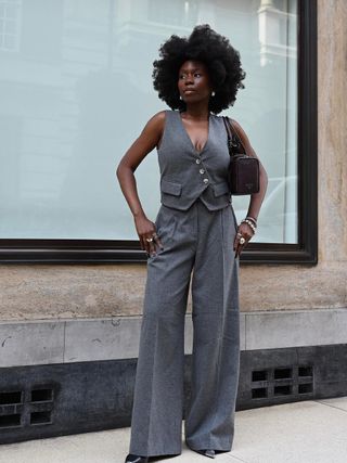photo of woman’s work outfit with gray wide-leg trousers and matching gray vest and heels