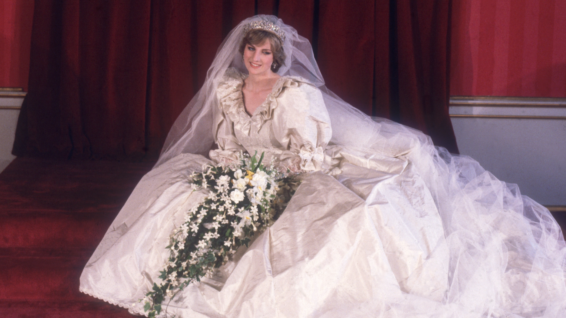 Princess Diana in her wedding dress sitting on the floor