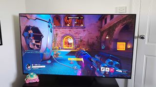 Hisense U7N with Overwatch 2 gameplay on screen with Pharah in first-person view