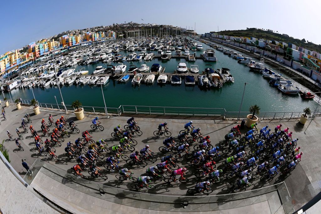 ALBUFEIRA PORTUGAL FEBRUARY 18 A general view of the peloton competing in Albufeira Harbour prior to the 49th Volta ao Algarve em Bicicleta 2023 Stage 4 a 1779km stage from Albufeira to Alto do Malho Loule 514m VAlgarve2023 on February 18 2023 in Albufeira Portugal Photo by Tim de WaeleGetty Images