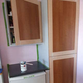 room with pain brush can and wooden cupboard