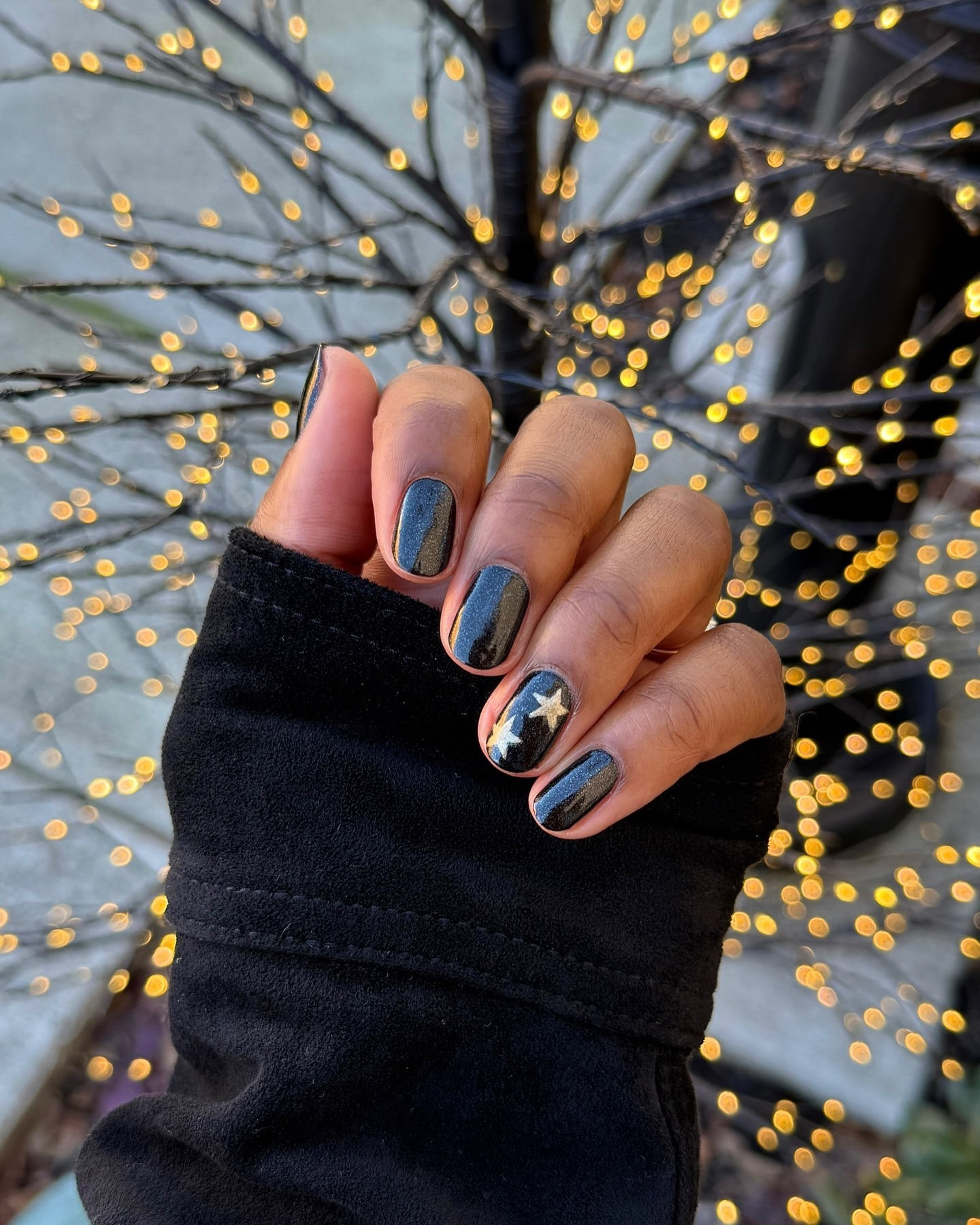 Black nail art with stars