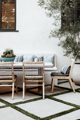 porch decor ideas with whitewashed wood chairs and bench seating around a dining table